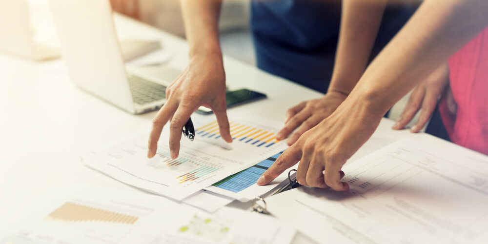 Two,Business,Women,Working,Together,On,Graphic,Data,Papers.,Startup